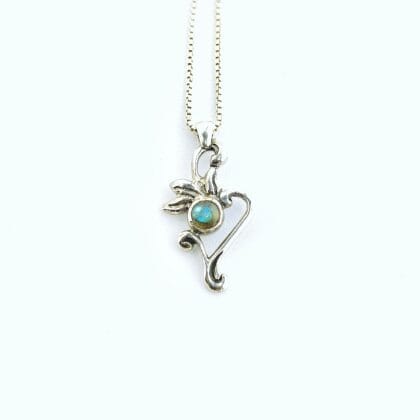Een zilveren hanger met een bloem en plantvormig hangertje en een ronde, blauw iriserende labradoriet cabochon in het midden.